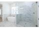 Bright bathroom features a large walk-in shower and a soaking tub near a window at 5623 Meadowstone Walk, Kennesaw, GA 30152