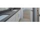 Bathroom with dual sinks, gray countertop, white cabinets, and tile flooring at 5623 Meadowstone Walk, Kennesaw, GA 30152