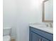Stylish half bathroom with blue vanity and modern fixtures at 5623 Meadowstone Walk, Kennesaw, GA 30152