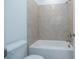 Clean bathroom with neutral tile in the shower and a standard toilet at 5623 Meadowstone Walk, Kennesaw, GA 30152