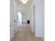 Bright hallway with hardwood floors leading to a living room with fireplace and large windows at 5623 Meadowstone Walk, Kennesaw, GA 30152