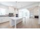 Spacious kitchen with a large island, white cabinets, and hardwood flooring at 5623 Meadowstone Walk, Kennesaw, GA 30152