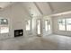 Bright living room featuring a fireplace, white walls, and natural light from large windows at 5623 Meadowstone Walk, Kennesaw, GA 30152