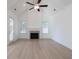 Bright living room features a fireplace, fan, cathedral ceilings, and large windows at 5623 Meadowstone Walk, Kennesaw, GA 30152