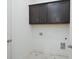 Well-lit mud room area with dark cabinets and tiled floors at 5623 Meadowstone Walk, Kennesaw, GA 30152