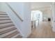 A view of the staircase and the open concept of the kitchen, dining room, and living area at 5623 Meadowstone Walk, Kennesaw, GA 30152