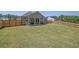 Spacious backyard with a wooden fence and lush grass, perfect for outdoor activities at 707 Ralph Still Rd, Dacula, GA 30019