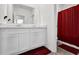 Bathroom featuring white cabinets and a red shower curtain, showcasing modern design at 707 Ralph Still Rd, Dacula, GA 30019