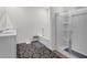 Bathroom with double vanity, tub, and glass enclosed shower with a dark patterned floor at 707 Ralph Still Rd, Dacula, GA 30019