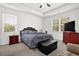 Bright bedroom with a large bed, two windows, and neutral decor with plenty of natural light at 707 Ralph Still Rd, Dacula, GA 30019