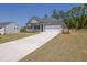 Attractive single-story home with a long concrete driveway, gray siding, and a neatly landscaped front yard at 707 Ralph Still Rd, Dacula, GA 30019