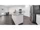 Bright kitchen featuring white cabinets, stainless steel appliances, and a center island with granite countertops at 707 Ralph Still Rd, Dacula, GA 30019