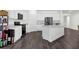 Contemporary kitchen featuring white cabinets, stainless steel appliances, a center island, and dark floors at 707 Ralph Still Rd, Dacula, GA 30019