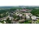 Stunning aerial view of a property showcasing lush greenery and a vibrant cityscape in the background at 211 Colonial Homes Nw Dr # 1105, Atlanta, GA 30309