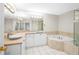 Bright bathroom featuring a sunken tub, vessel sink, updated fixtures and large mirror at 211 Colonial Homes Nw Dr # 1105, Atlanta, GA 30309