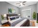 This staged bedroom offers a ceiling fan and plenty of natural light from the window at 211 Colonial Homes Nw Dr # 1105, Atlanta, GA 30309