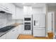 Bright kitchen featuring white cabinets, granite countertops, and stainless steel appliances at 211 Colonial Homes Nw Dr # 1105, Atlanta, GA 30309