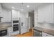 Updated kitchen featuring white cabinetry, stainless steel appliances, and modern fixtures at 211 Colonial Homes Nw Dr # 1105, Atlanta, GA 30309
