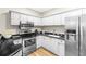 Modern kitchen with white cabinets, stainless steel appliances, and granite countertops at 211 Colonial Homes Nw Dr # 1105, Atlanta, GA 30309