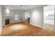Open living room featuring hardwood floors, a fireplace, and access to the kitchen at 211 Colonial Homes Nw Dr # 1105, Atlanta, GA 30309