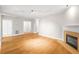 Spacious living room featuring hardwood floors, a fireplace, and neutral paint colors at 211 Colonial Homes Nw Dr # 1105, Atlanta, GA 30309