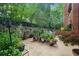 Lush garden patio with mature trees and shrubs creating a serene outdoor retreat at 211 Colonial Homes Nw Dr # 1105, Atlanta, GA 30309