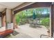 Charming outdoor patio with a dining set, lush greenery, and privacy fencing at 211 Colonial Homes Nw Dr # 1105, Atlanta, GA 30309