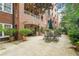 Beautiful outdoor patio with seating area and lush landscaping, perfect for relaxation at 211 Colonial Homes Nw Dr # 1105, Atlanta, GA 30309