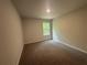 Carpeted bedroom offers a peaceful setting with a window view of the outdoors at 30 Yellow Brick Way, Covington, GA 30014