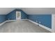 Finished attic space with blue walls, grey carpeting, and natural light from a window at 610 Valley Green Trce, Marietta, GA 30068