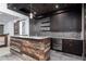Entertainers bar features a wood facade and includes stone countertops and modern appliances at 610 Valley Green Trce, Marietta, GA 30068