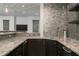 The bar area is accentuated by stone tile backsplashes and granite countertops at 610 Valley Green Trce, Marietta, GA 30068