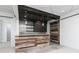 Finished basement featuring a rustic bar with wood accents and sliding barn door at 610 Valley Green Trce, Marietta, GA 30068