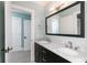 Bathroom featuring dual sinks, marble countertops, modern fixtures, and walk-in access at 610 Valley Green Trce, Marietta, GA 30068