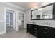 Neutral bathroom with double sinks, vanity, and entrances to both a closet and bedroom at 610 Valley Green Trce, Marietta, GA 30068