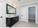 Bright bathroom with a dual sink vanity, a large mirror, and tile flooring at 610 Valley Green Trce, Marietta, GA 30068