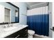Bathroom featuring marble countertop vanity, toilet, and shower with blue ombre curtain at 610 Valley Green Trce, Marietta, GA 30068