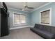 Cozy bedroom with a futon sofa, carpet flooring, and dual windows providing natural light at 610 Valley Green Trce, Marietta, GA 30068