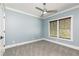 Bedroom featuring gray carpet, neutral paint, modern ceiling fan, and natural light from windows at 610 Valley Green Trce, Marietta, GA 30068
