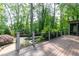 Large wooden deck overlooking a pool with lush landscaping, creating a private oasis at 610 Valley Green Trce, Marietta, GA 30068
