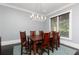 Formal dining room featuring a wooden table, classic chairs, and a modern chandelier at 610 Valley Green Trce, Marietta, GA 30068