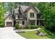 Beautiful two-story home showcasing a brick and siding facade, complemented by a lush green lawn at 610 Valley Green Trce, Marietta, GA 30068