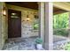 Inviting front porch with stone flooring, elegant columns, and a view of the surrounding landscape at 610 Valley Green Trce, Marietta, GA 30068