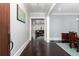 Elegant hallway with dark wood floors leading to a living room and dining area at 610 Valley Green Trce, Marietta, GA 30068
