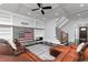 The living room features a stone fireplace with American flag decor, built-in shelves and a leather sofa at 610 Valley Green Trce, Marietta, GA 30068