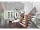 Light-filled living room with coffered ceiling, fireplace, staircase, and French doors to the outside at 610 Valley Green Trce, Marietta, GA 30068