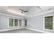 Spacious main bedroom featuring a tray ceiling, a ceiling fan, and many windows providing natural light at 610 Valley Green Trce, Marietta, GA 30068