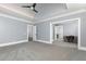 Bright main bedroom with tray ceilings, carpeted floor, and adjoining sitting room with desk and chair at 610 Valley Green Trce, Marietta, GA 30068