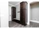 Mudroom featuring dark wood cabinetry, a built-in bench, and stylish gray tile flooring at 610 Valley Green Trce, Marietta, GA 30068