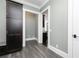 Hallway with dark wood storage units and seating area, leading to an open kitchen at 610 Valley Green Trce, Marietta, GA 30068
